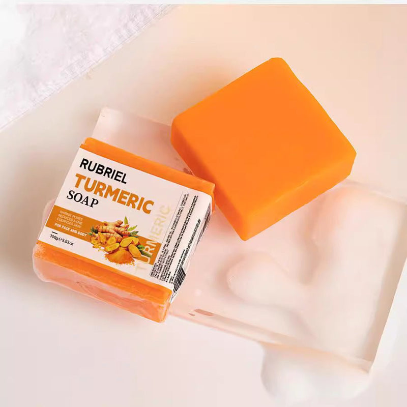 Golden Glow Turmeric Facial Soap bar with bright orange color and creamy lather on white background